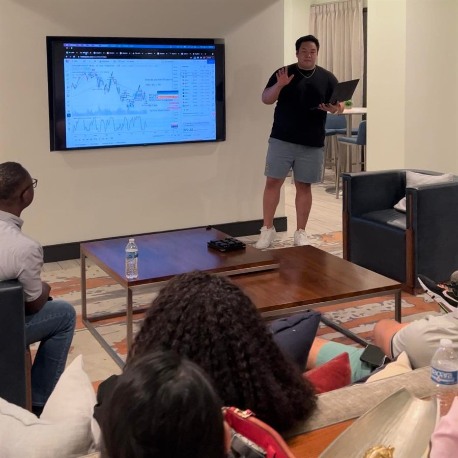 Justin breaking down a live chart on screen for a room of students