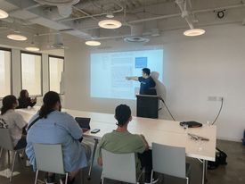 Justin presenting a trading seminar to a seated classroom
